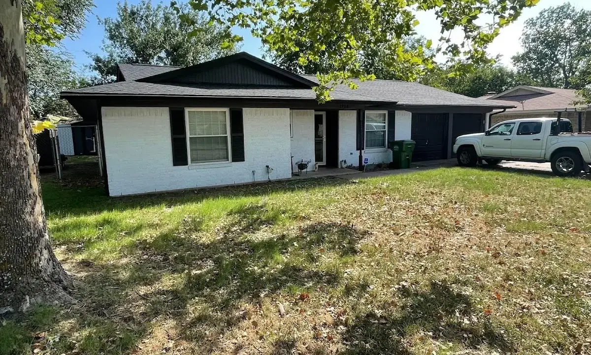Professional roofing crew working on a residential roof in West Carrollton